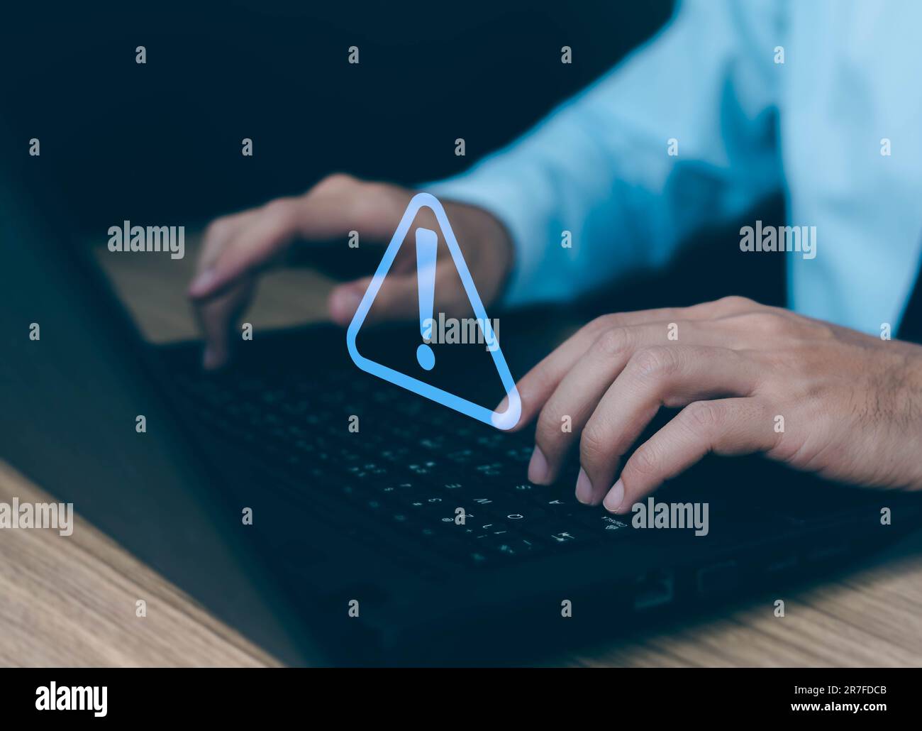 Businessman using computer laptop with triangle caution warning sing for notification error and maintenance concept. Stock Photo