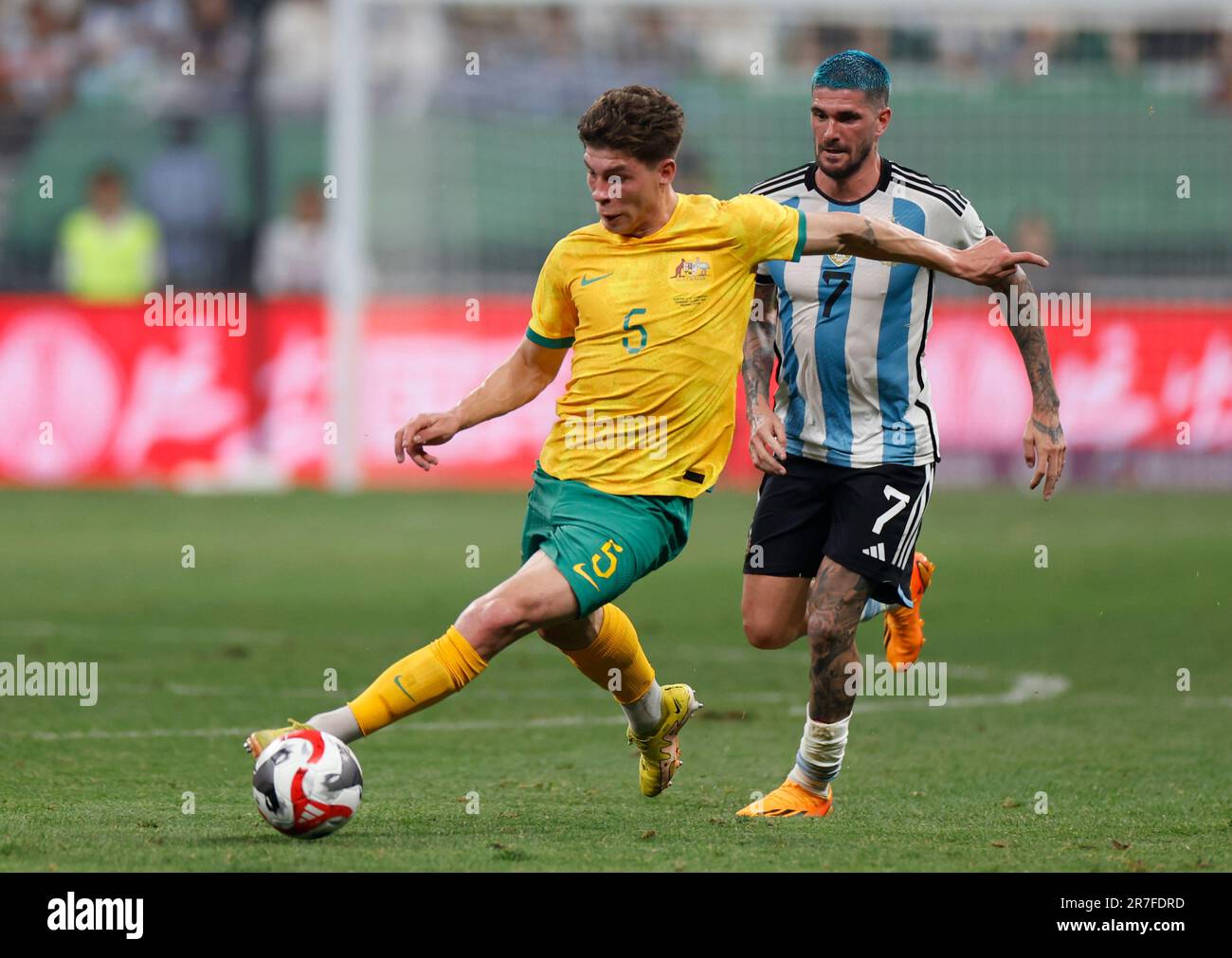 Beijing, China. 15th June, 2023. Jordan Bos (front) of Australia vies with Rodrigo de Paul of Argentina during an international football invitational between Argentina and Australia in Beijing, capital of China, June 15, 2023. Credit: Zhang Chen/Xinhua/Alamy Live News Stock Photo