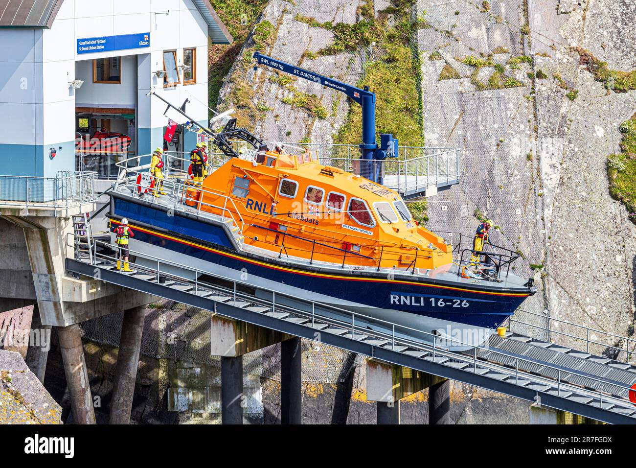 Cleaning the Tamar class lifeboat RNLB Norah Wortley after an exercise at the new lifeboat station at St Justinians, Pembrokeshire, Wales UK Stock Photo