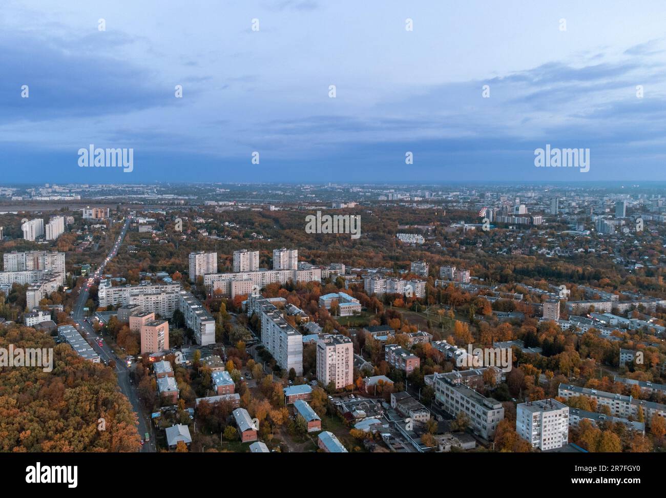 Aerial autumn evening city view. Residential district with park and dark blue cloudy sky. Kharkiv, Ukraine Stock Photo