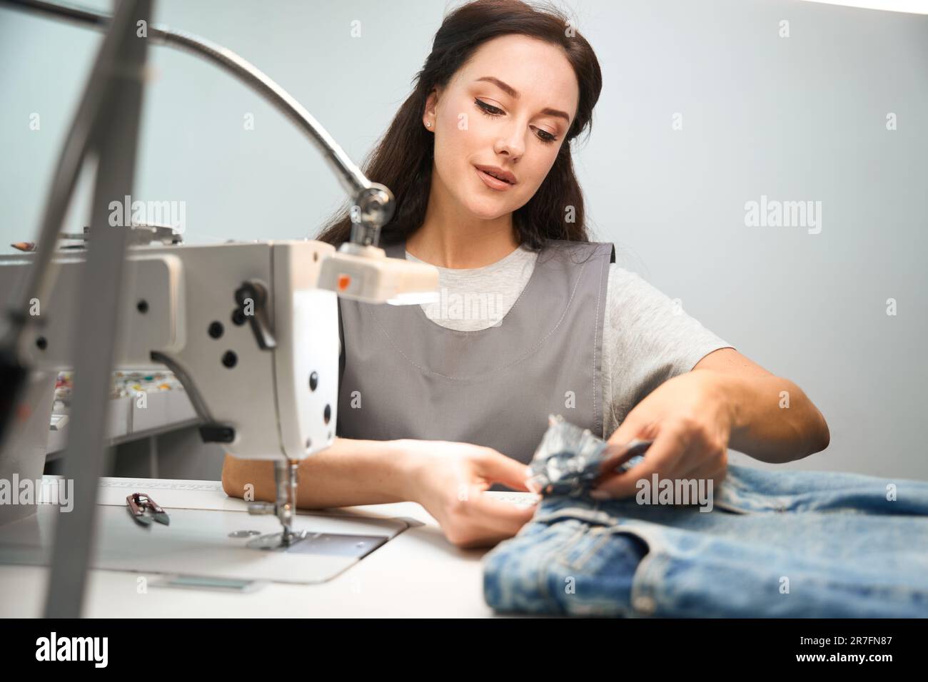 Drycleaning office worker covering buttons and embellishments Stock