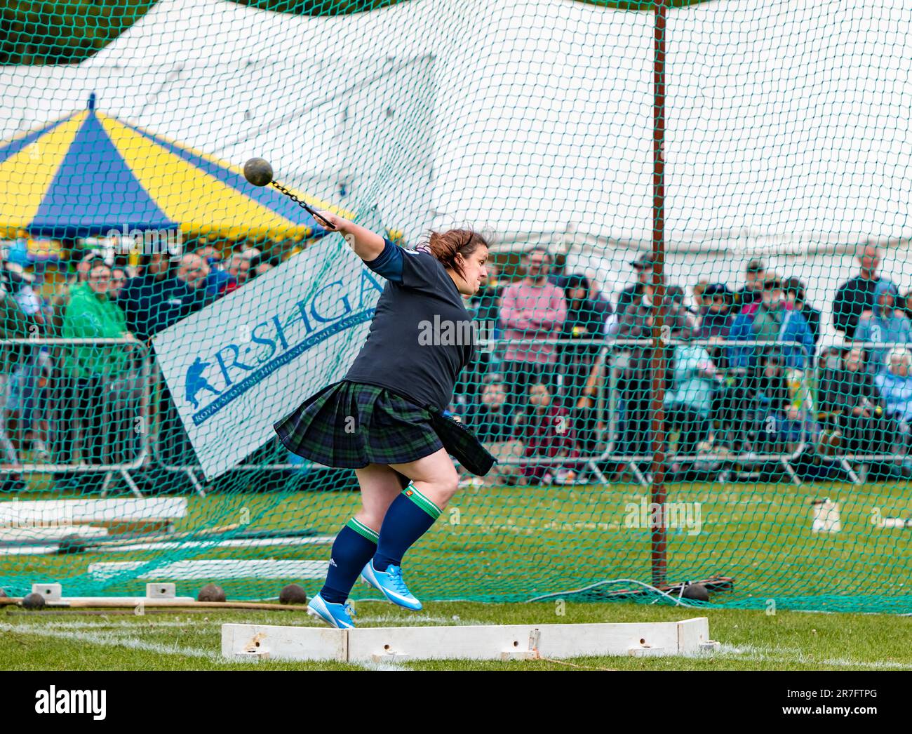 Female competittor in heavy ball and chain game event, Highland Games