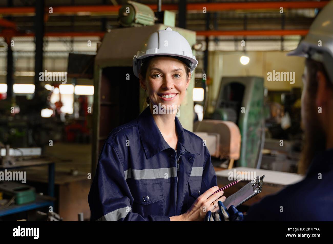 Mechanical engineers repairing engine machine at factory Stock Photo ...