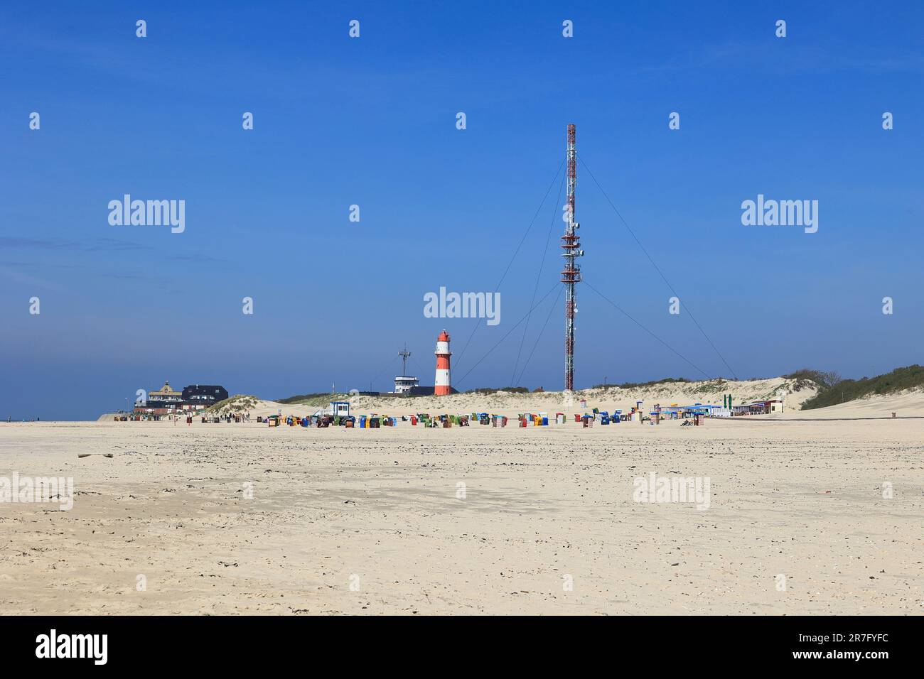 Electric lighthouse and new radio mast on Borkum beach Stock Photo