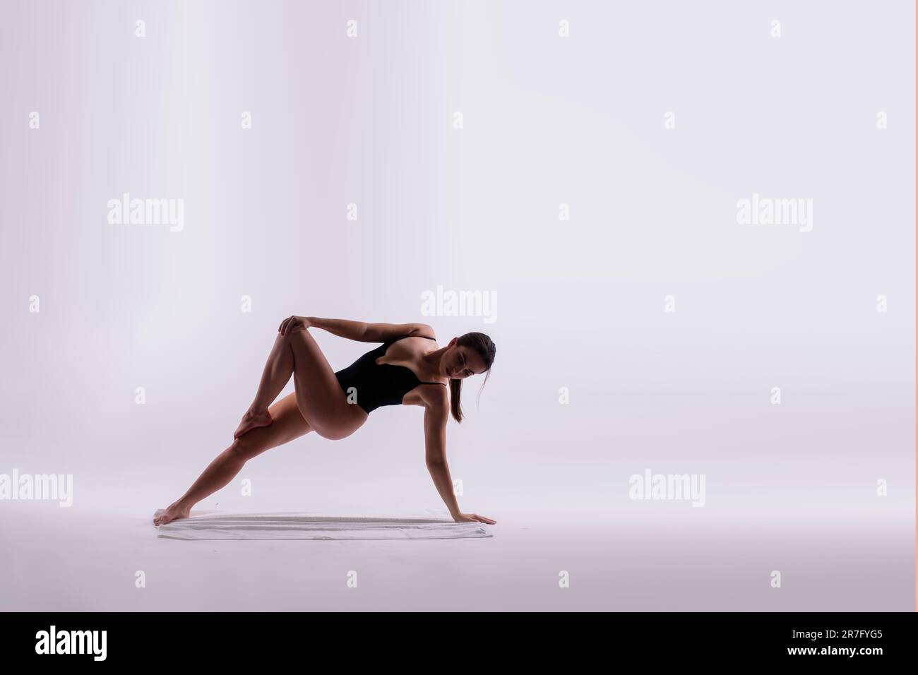 Beautiful woman doing poses on yoga class. Studio shot. Stock Photo