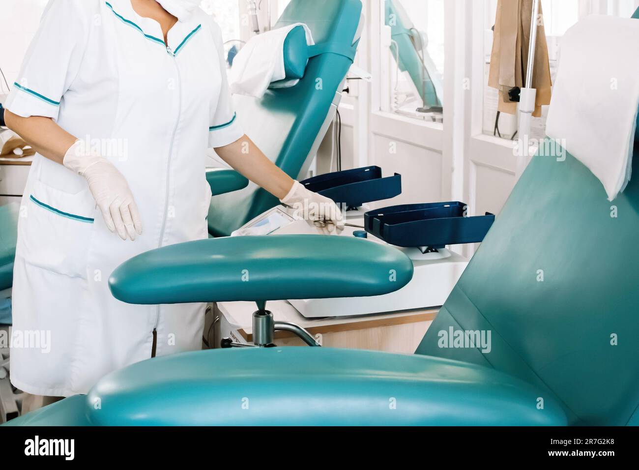 Nurse prepares chair for blood donors in medical laboratory. International Blood Donation Day. Equipment for blood transfusion in city blood bank. Stock Photo