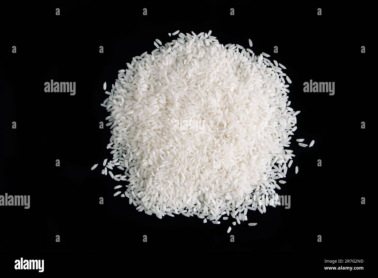 Pile of uncooked white rice on black background. Natural organic vegan ...