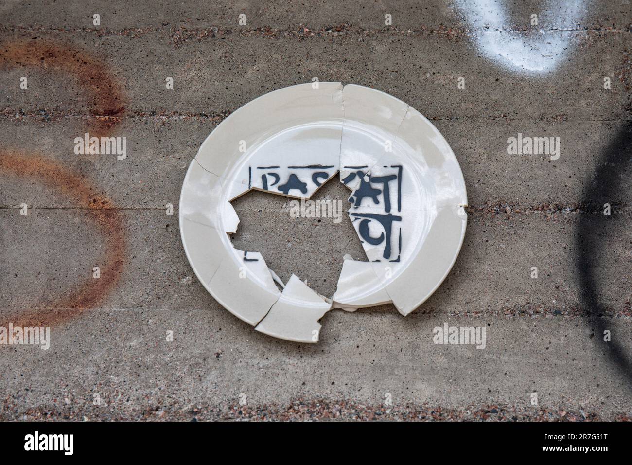 Street art. Broken Paskat Talkoot plate by artist Plan B in Helsinki, Finland. Stock Photo