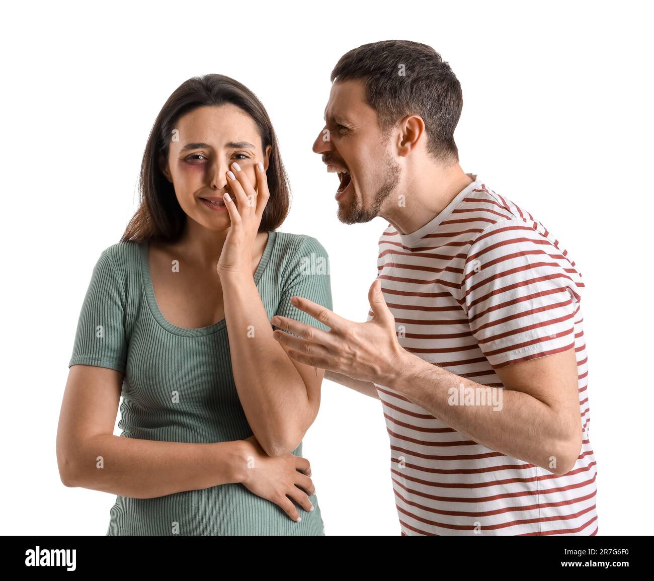 Angry young man shouting at his crying wife on white background. Domestic violence concept Stock Photo