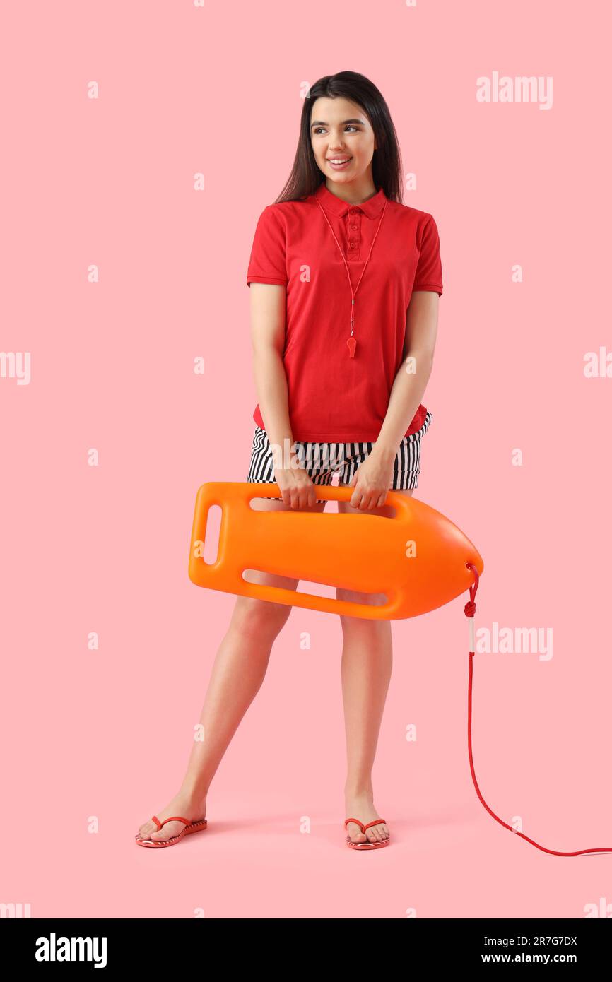 Female lifeguard with board on pink background Stock Photo - Alamy