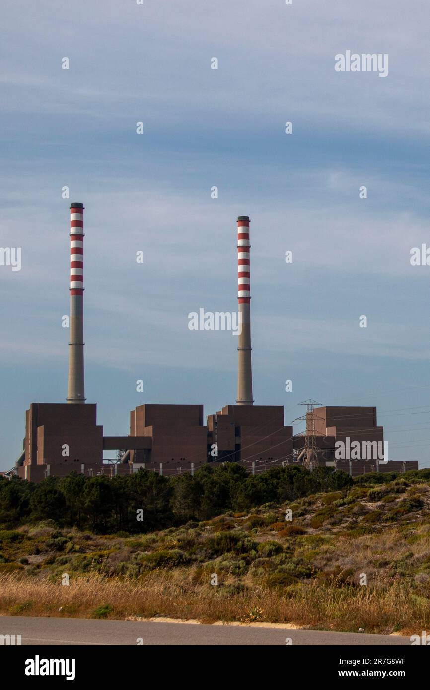 Industrial plant. Factory producing electricity with two huge chimneys Stock Photo