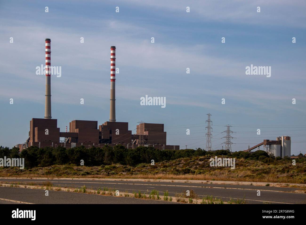 Industrial plant. Factory producing electricity with two huge chimneys Stock Photo
