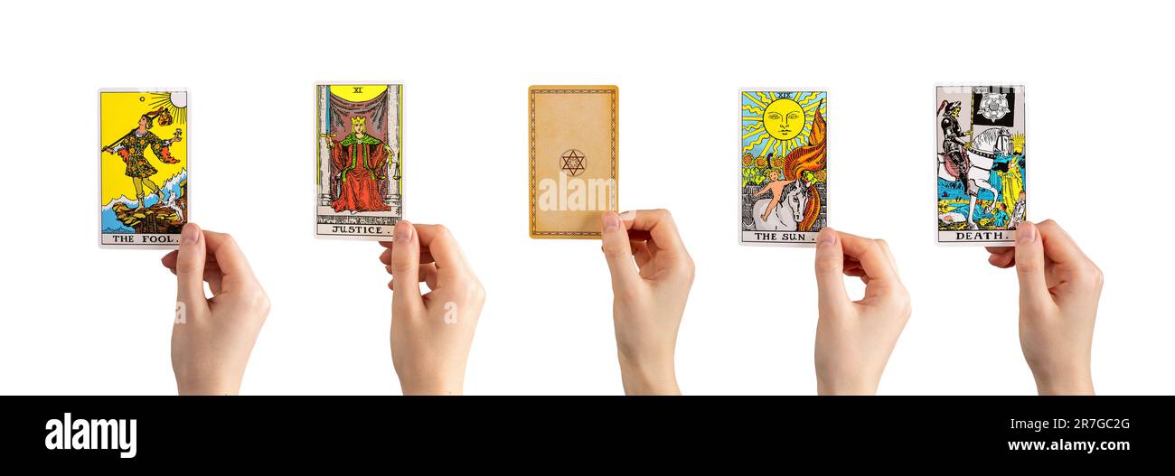 Lodz Poland June 11 2023 Tarot cards in hands set, major arcanas of Fool, Emperor, Sun, Death isolated on white background. Stock Photo