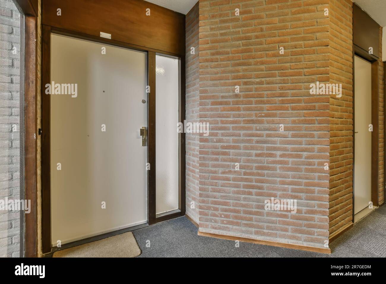 an empty room with brick walls and wood trims on the wall, there is a