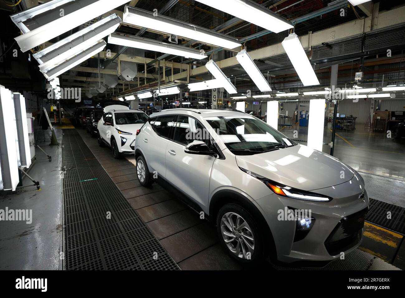 An assembly line worker looks over a 2023 Chevrolet Bolt EUV at the General Motors Orion
