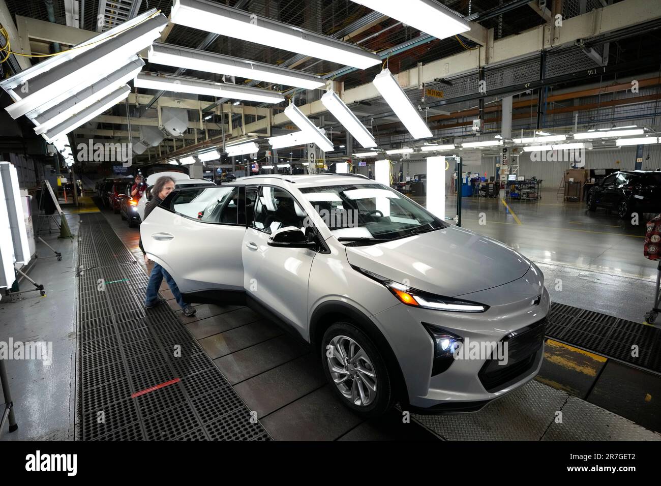 An assembly line worker looks over a 2023 Chevrolet Bolt EUV at the General Motors Orion