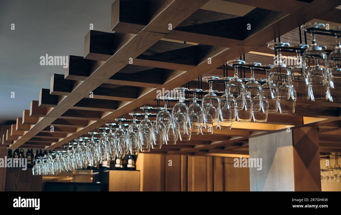 Wine glasses hang above bar counter Stock Photo Alamy