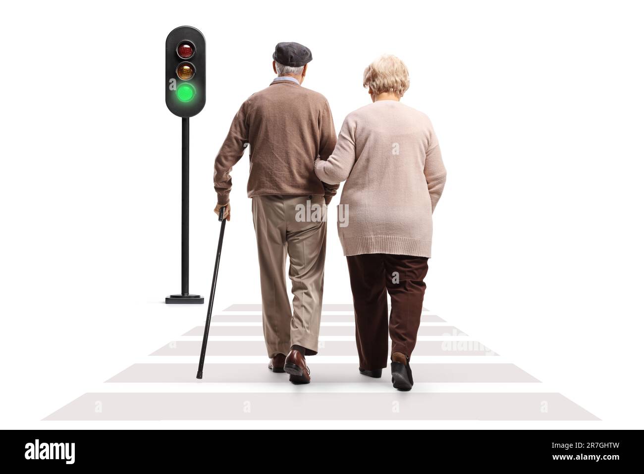 Full length rear view shot of a senior man and woman walking at a pedestrian crosswalk isolated on white background Stock Photo