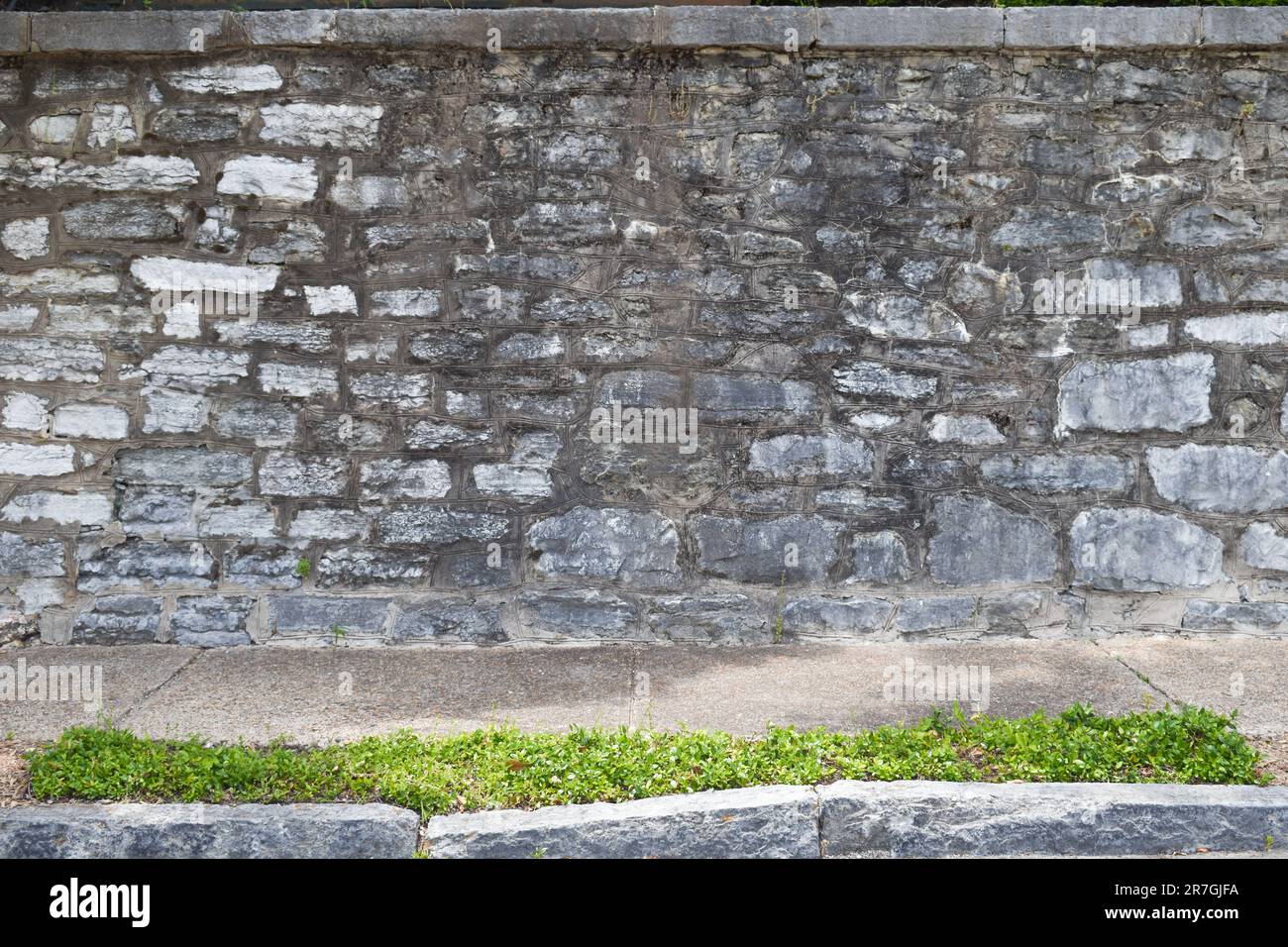 Large stone wall ledge sidewalk background Stock Photo