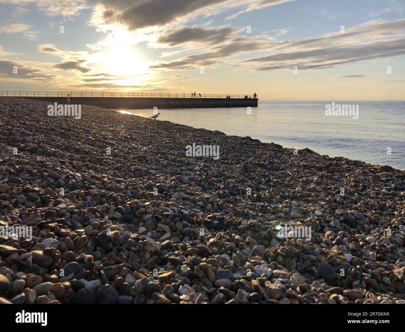 Looking Across a Decorative Stack of Different Coloured Stones, Pebbles and Cobbles at Hampton Stone Beach, Hampton Pier in the Distance. Stock Photo