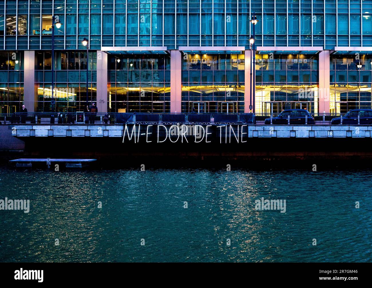London, UK - January 17 2020:  The light artwork Mi-e-dor-de-tine is illuminated over Middle Dock at the Winter Lights Festival in Canary Wharf Stock Photo
