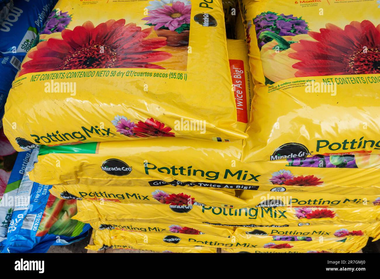 Stacked bags of Miracle Gro potting mix containing soil with fertilizer for sale at a garden center in Wichita, Kansas, USA. Stock Photo