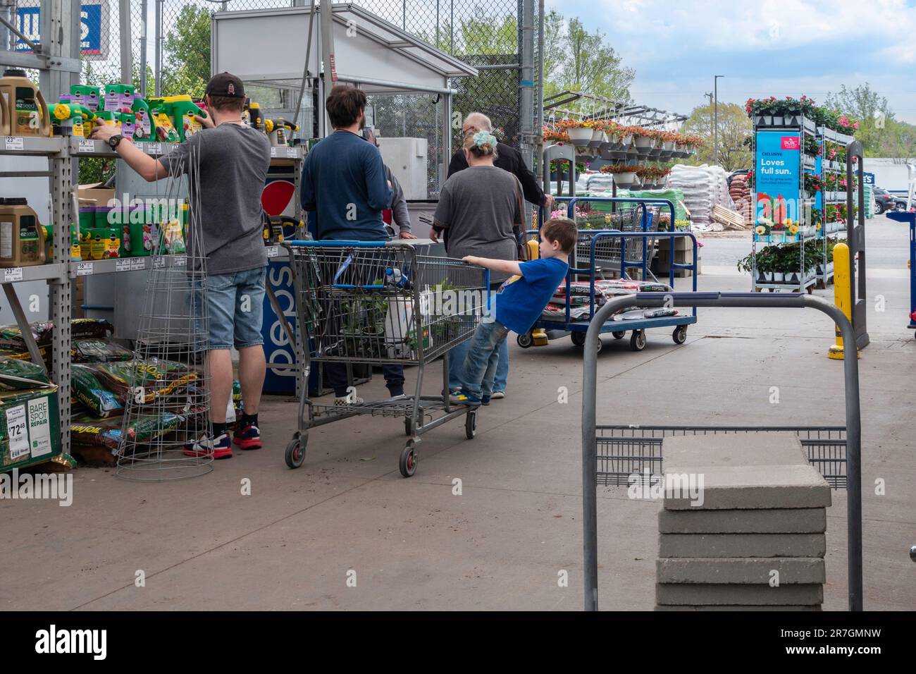 Customers stand in line to pay for plants and merchandise at cashier’s stand at Lowe’s garden center in Wichita, Kansas, USA. Stock Photo