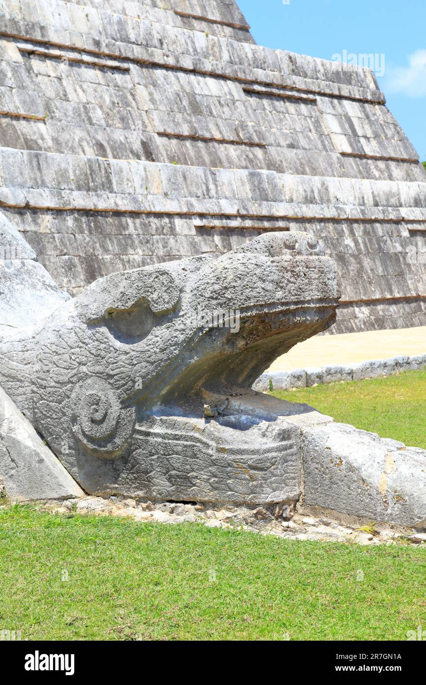 A Head of Kukulcan serpent at the base of The Castle, El Castillo or Pyramid of Kukulcan at Chichen Itza, Yucatan, Yucatan Peninsular, Mexico. Stock Photo