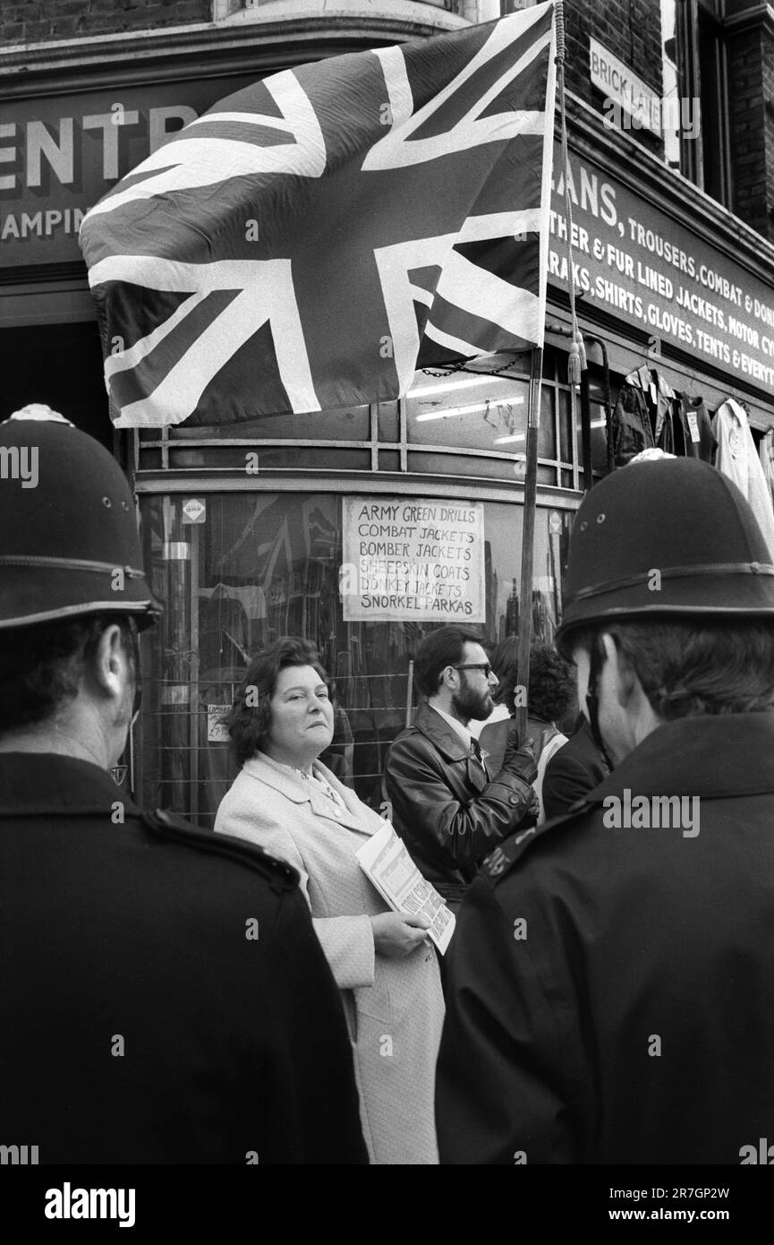 National Front supporters sell the National Front News, every Sunday morning at the junction of Brick Lane and Bethnal Green Road. London. There was a regular stand off, with police and Socialist Workers Party members selling their weekly newspaper. Whitechapel, east London, England circa 1976.  1970S UK HOMER SYKES Stock Photo