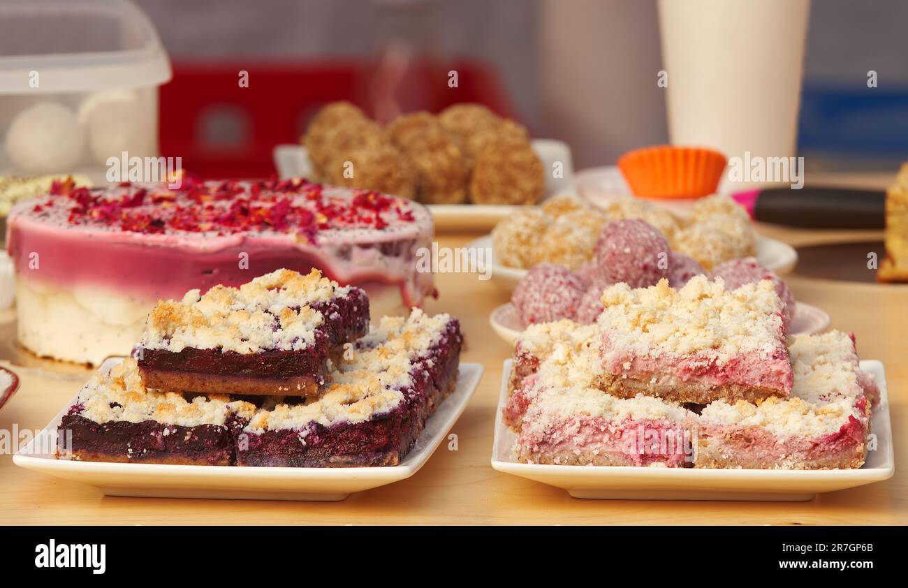 Fruit cakes, tarts, brownies and other tasty desserts and delicacies on sale at the confectionery stand at the Prague Farmers Street Food Market Stock Photo