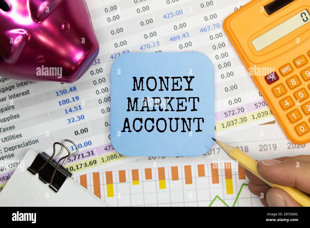 MONEY MARKET ACCOUNT text on blue pieces of paper on yellow background, business concept Stock Photo