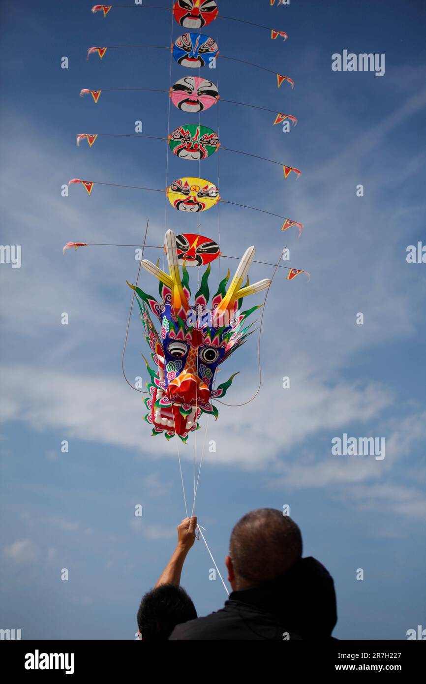 Fanoe, Denmark. 15th June, 2023. A man flies a Chinese traditional dragon kite during an international kite festival in Fanoe, Denmark, on June 11, 2023. Fanoe, a small island off Denmark's west coast, has been aflutter with over 20,000 colorful kites bobbing against the sky, signaling that the China to Fanoe Culture Week, which runs until June 16, is at full swing. Credit: Lin Jing/Xinhua/Alamy Live News Stock Photo