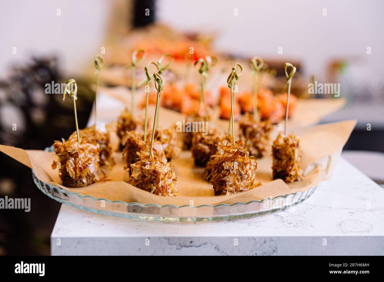 Catering food at a wedding party. Food styling and restaurant meal serving. Tuna canapes on bamboo skewers with tuna shavings. Stock Photo