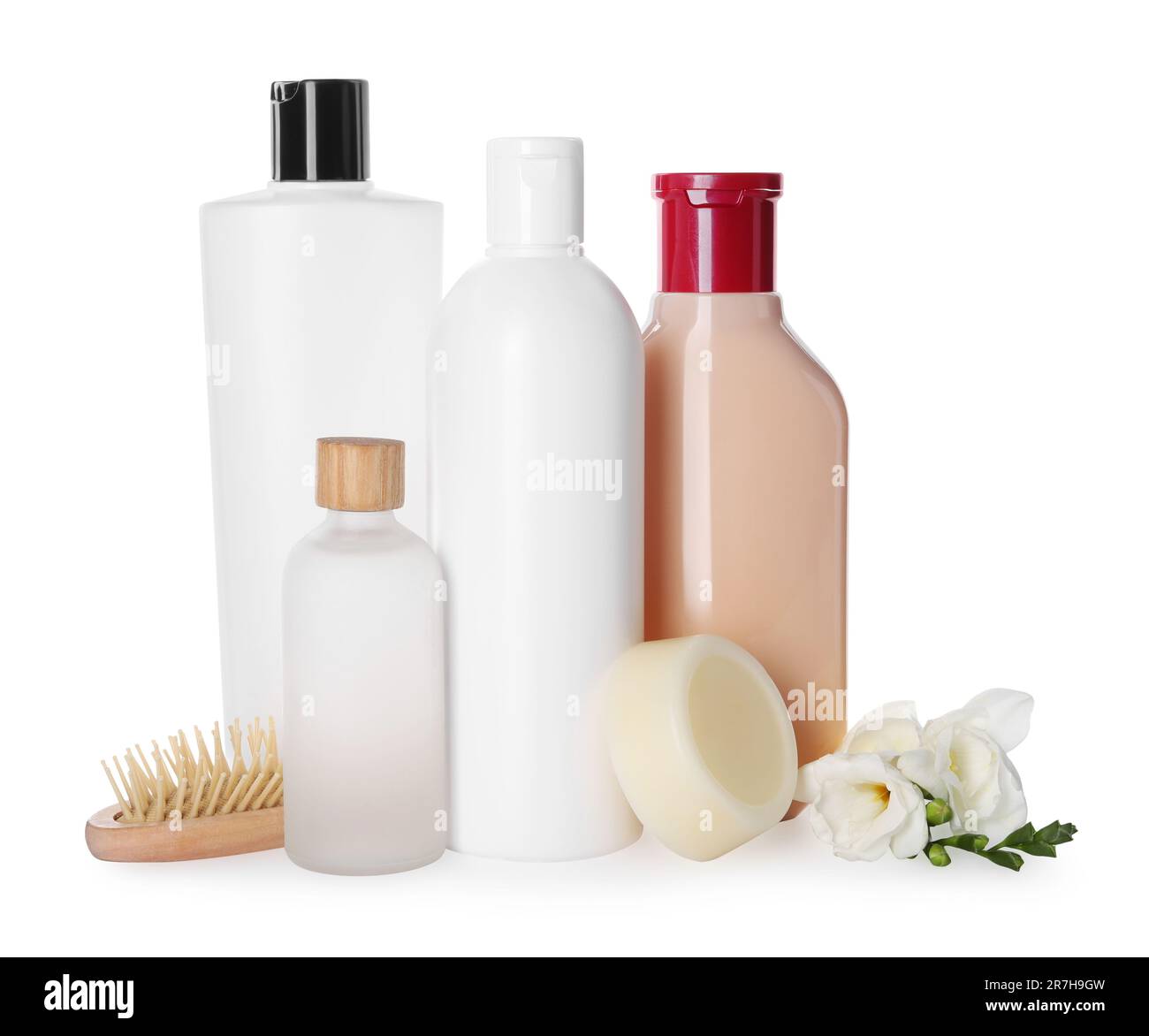 Different bottles of shampoo and wooden brush on white background Stock ...