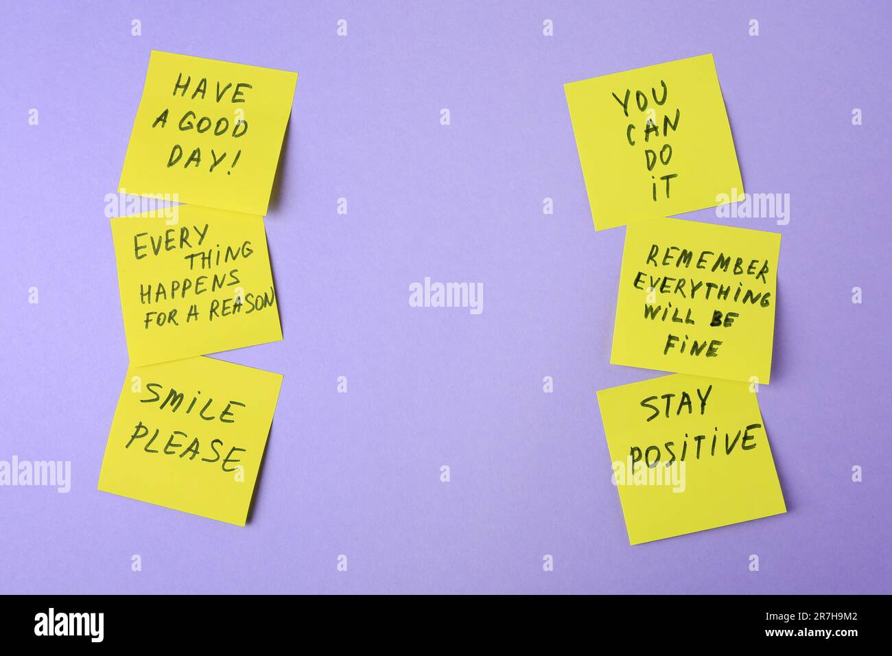 Paper notes with life-affirming phrases on violet background. Space for text Stock Photo