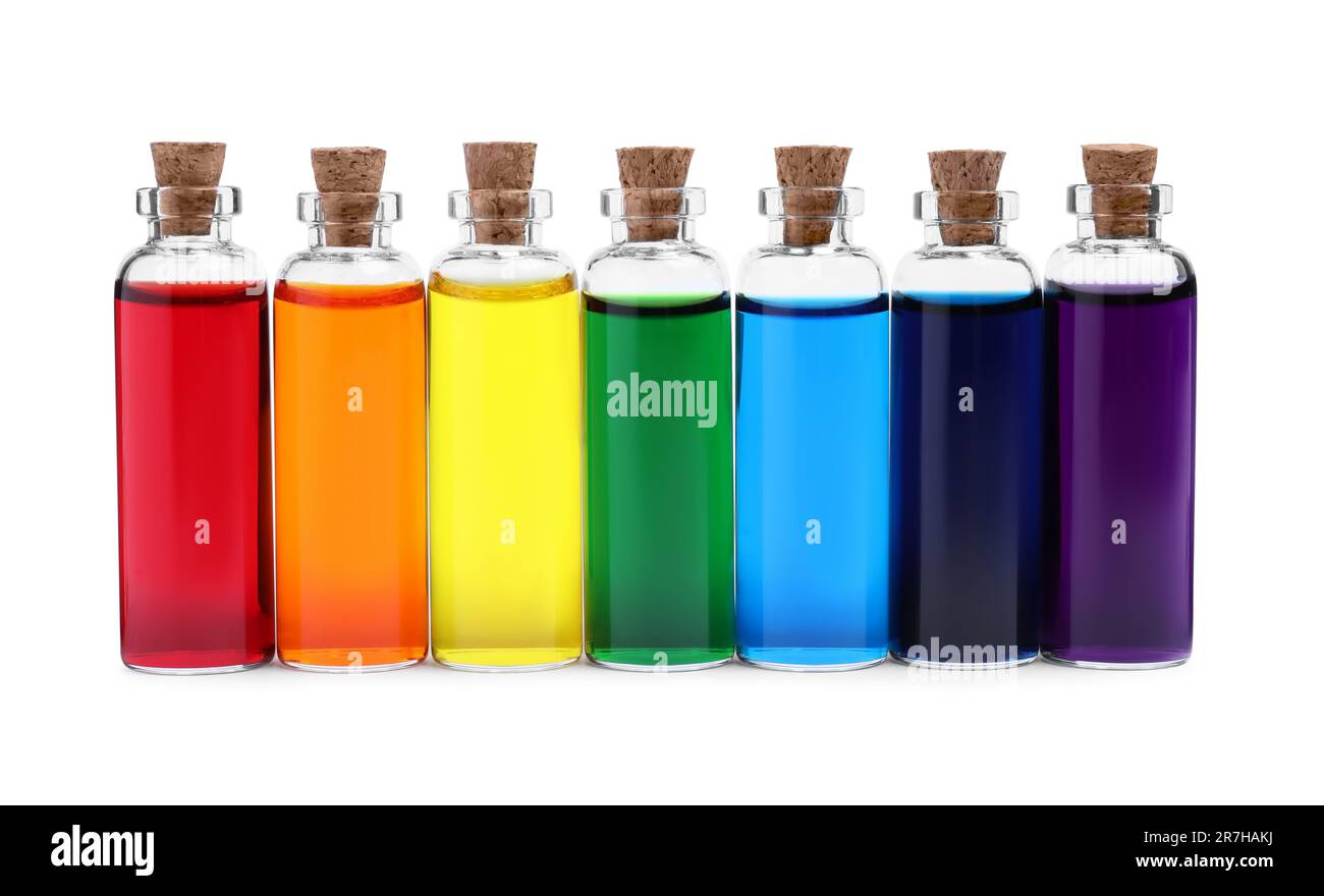 Glass bottles with different food coloring on white background Stock Photo