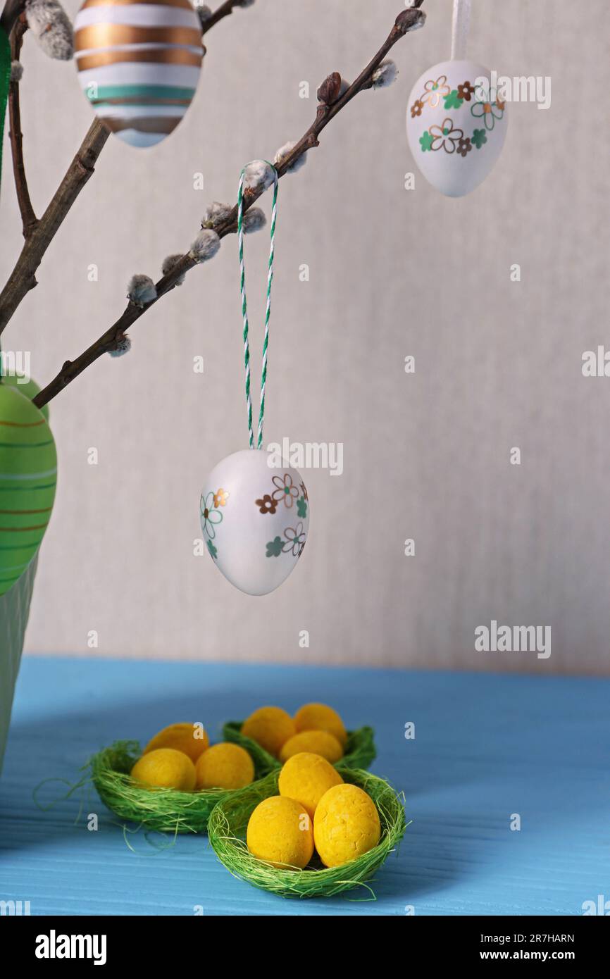 Beautiful willow branches with painted eggs and Easter decor on light ...
