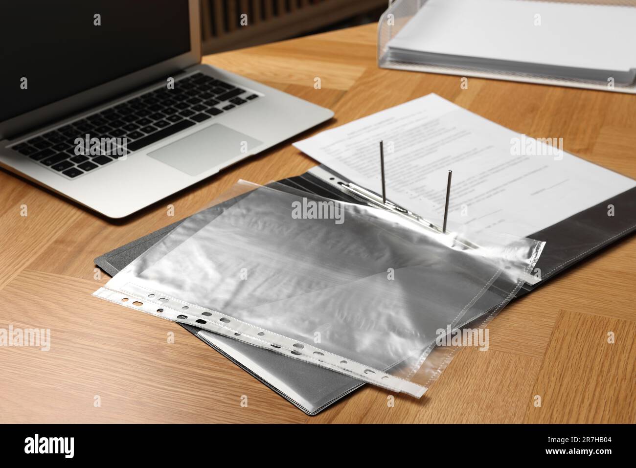 File folder with punched pockets on wooden table Stock Photo