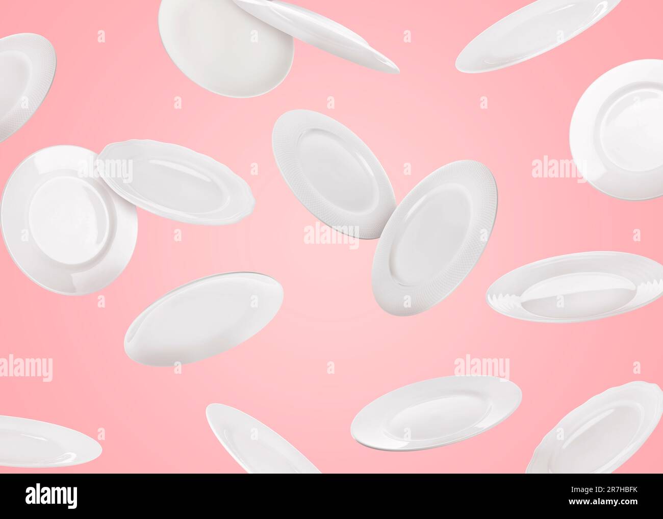 Many white plates falling on pastel pink background Stock Photo - Alamy