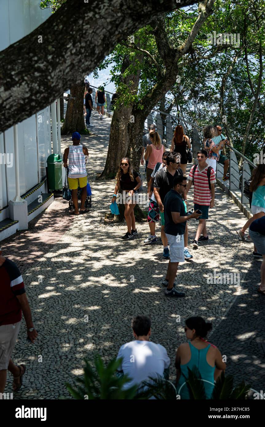 Tourists walking around the outdoor area on Urca hill summit in Urca district, nearby the food court and observation decks in a summer sunny day. Stock Photo