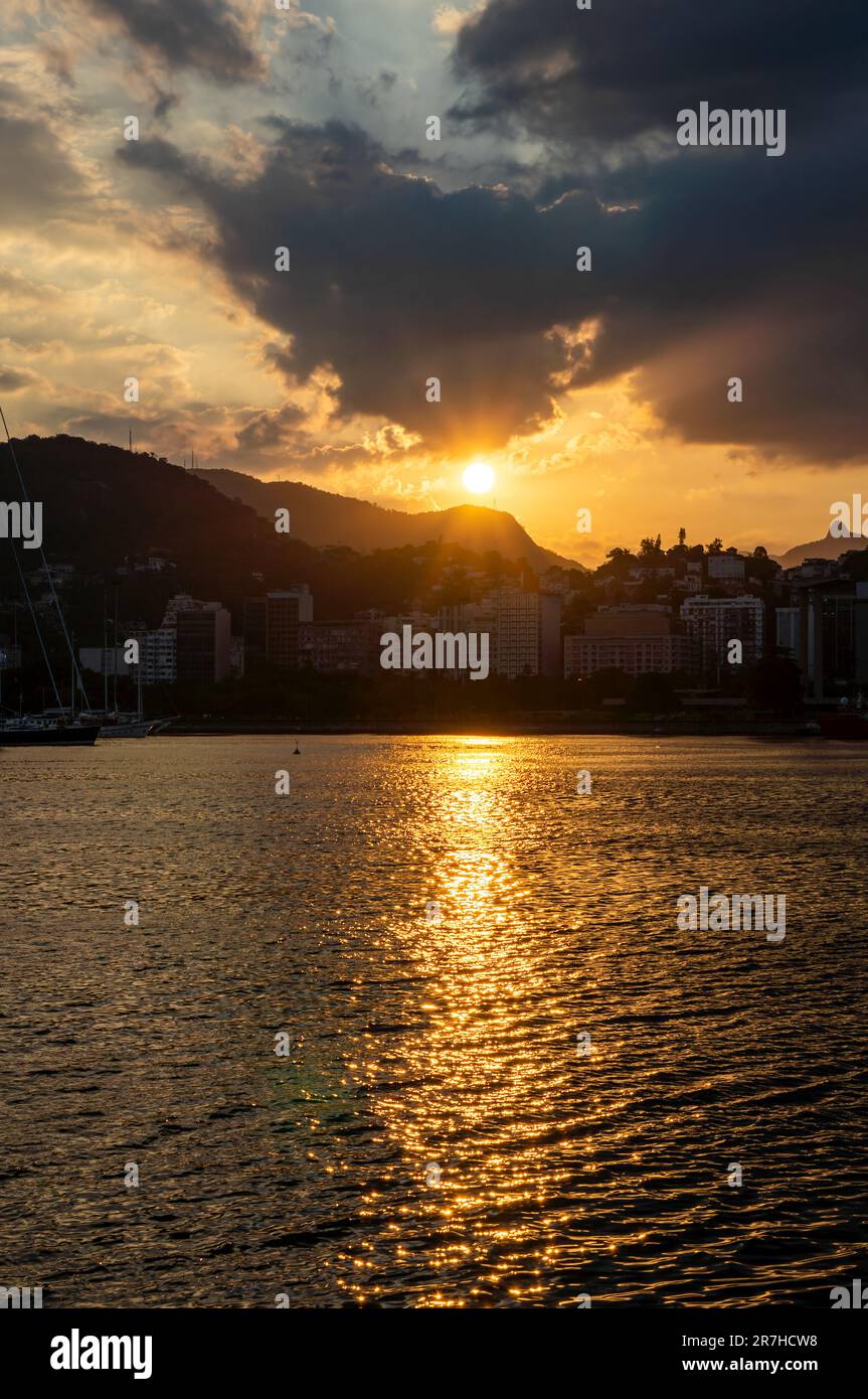 Sunset view as saw from Almirante Silvio de Noronha avenue, nearby Santos Dumont airport of Gloria district coastline under summer late afternoon sky. Stock Photo