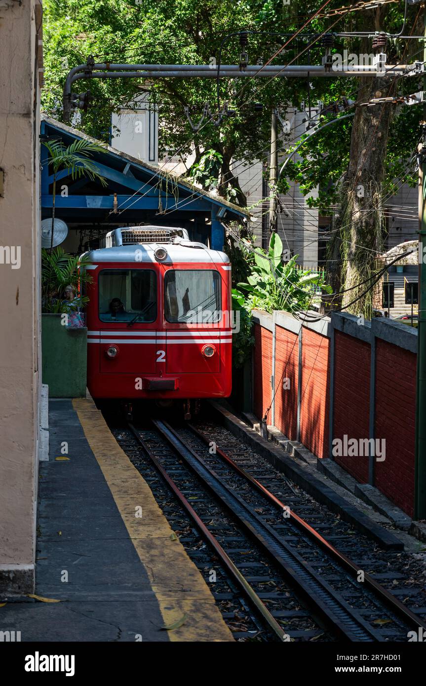 The old red SLM Bhe 2-4 Nº 2 rail car from Corcovado Rack Railway at Cosme Velho station unloading passengers before depart heading Corcovado mountain. Stock Photo