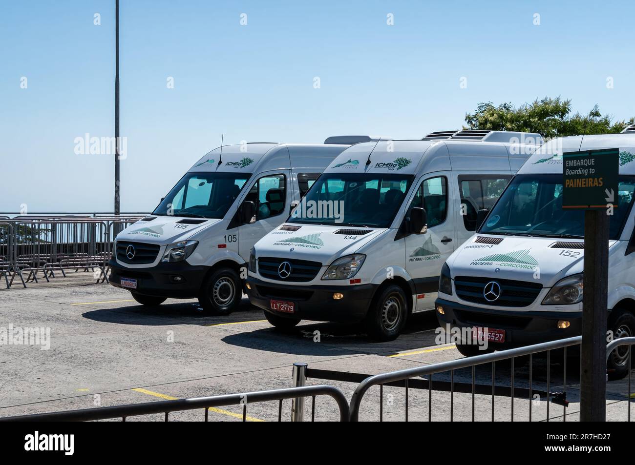 Mercedes-Benz Sprinter vans parked on the summit of Corcovado mountain, used to transport tourists to the top nearby Christ the Redeemer statue. Stock Photo