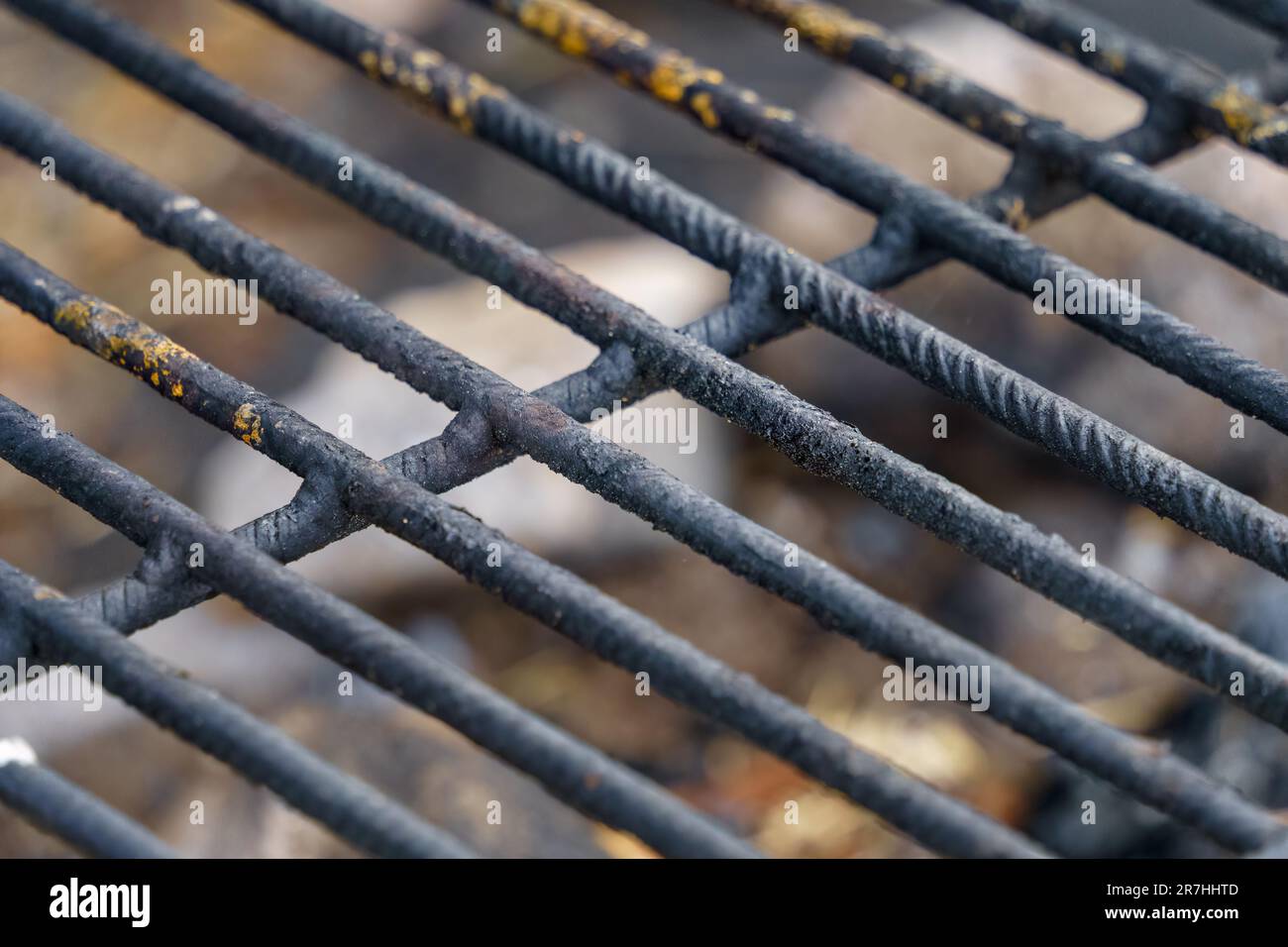 Close up of a black rebar metal grill in outdoors campfire site Stock