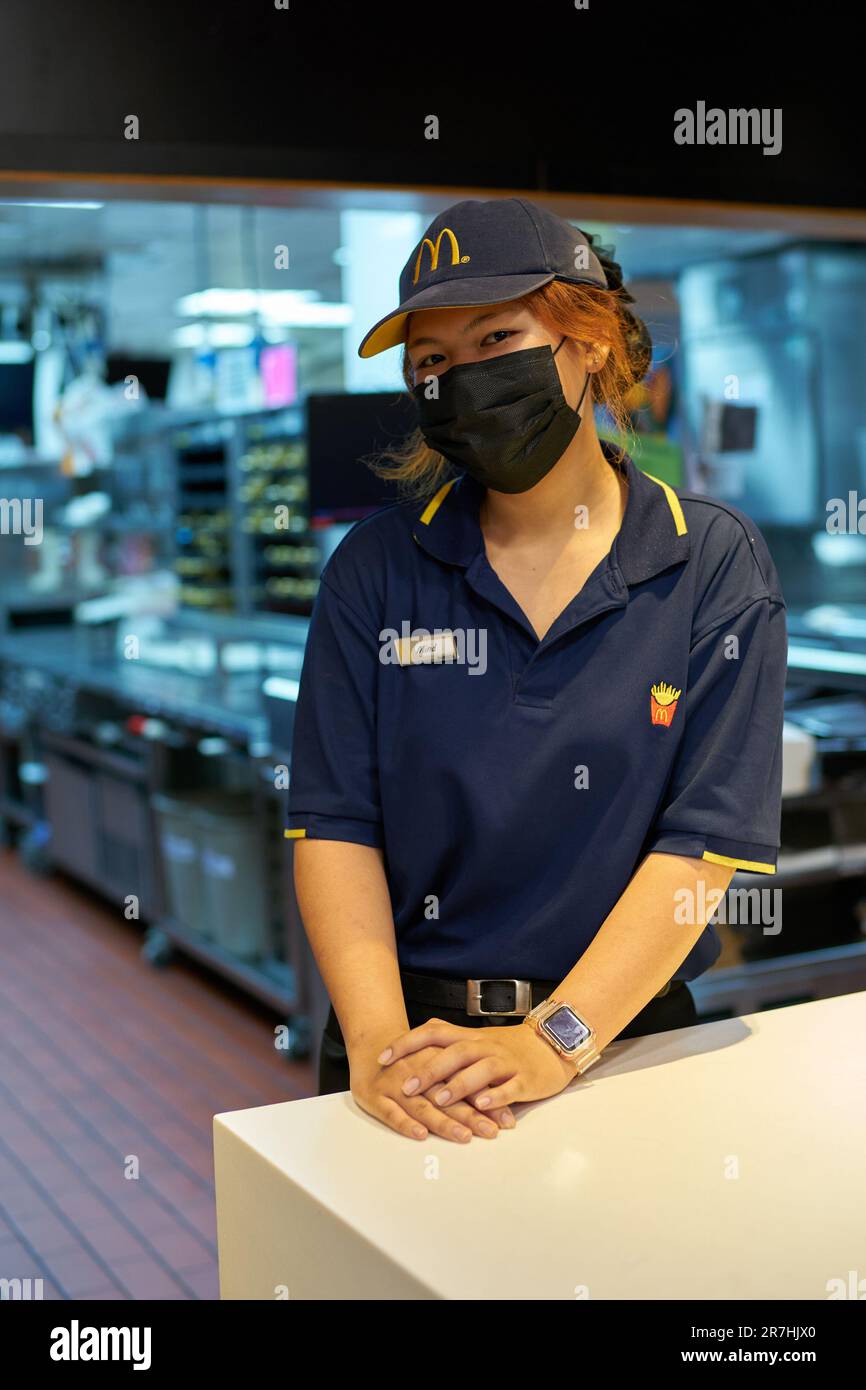 PATTAYA, THAILAND - CIRCA APRIL, 2023: indoor portrait of McDonald's fast food restaurant employee in Pattaya. Stock Photo