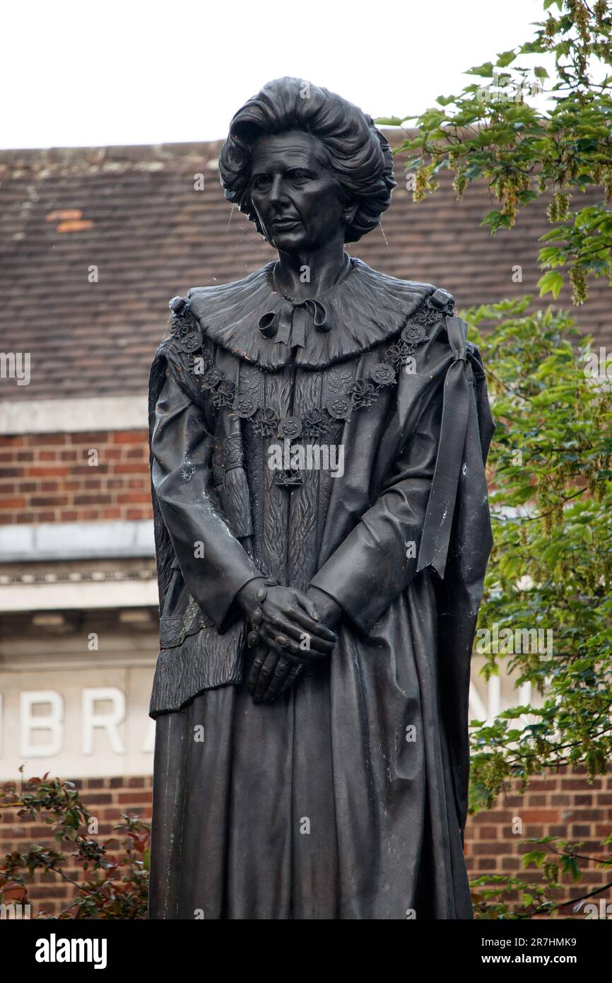 The statue of Margaret Thatcher standing in her birthplace, the town of Grantham in Lincolnshire, England. The statue is 10 feet 6 inches high, cast in bronze, and depicts the late British prime minister Baroness Thatcher, dressed in the full ceremonial robes of the House of Lords. The statue has been vandalised but is pictured without damage. Stock Photo