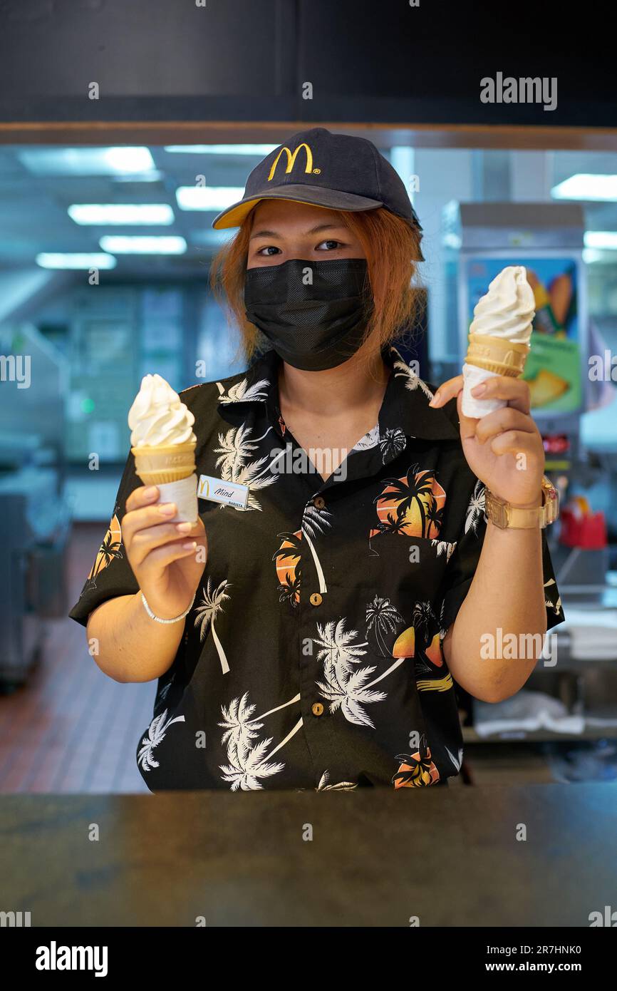 PATTAYA, THAILAND - CIRCA APRIL, 2023: portrait of McDonald's fast food restaurant employee with ice cream in Pattaya. Stock Photo