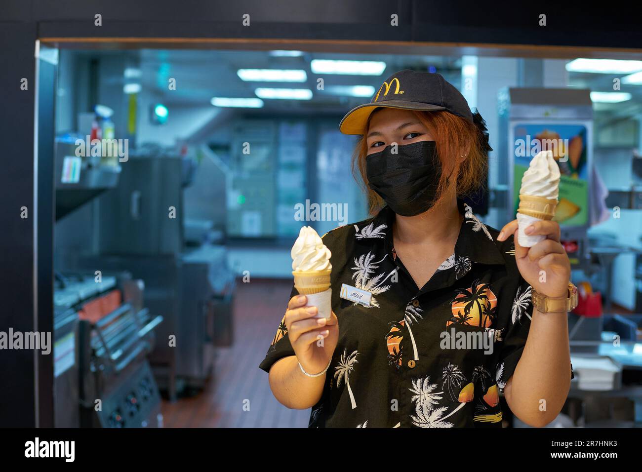 PATTAYA, THAILAND - CIRCA APRIL, 2023: portrait of McDonald's fast food restaurant employee with ice cream in Pattaya. Stock Photo