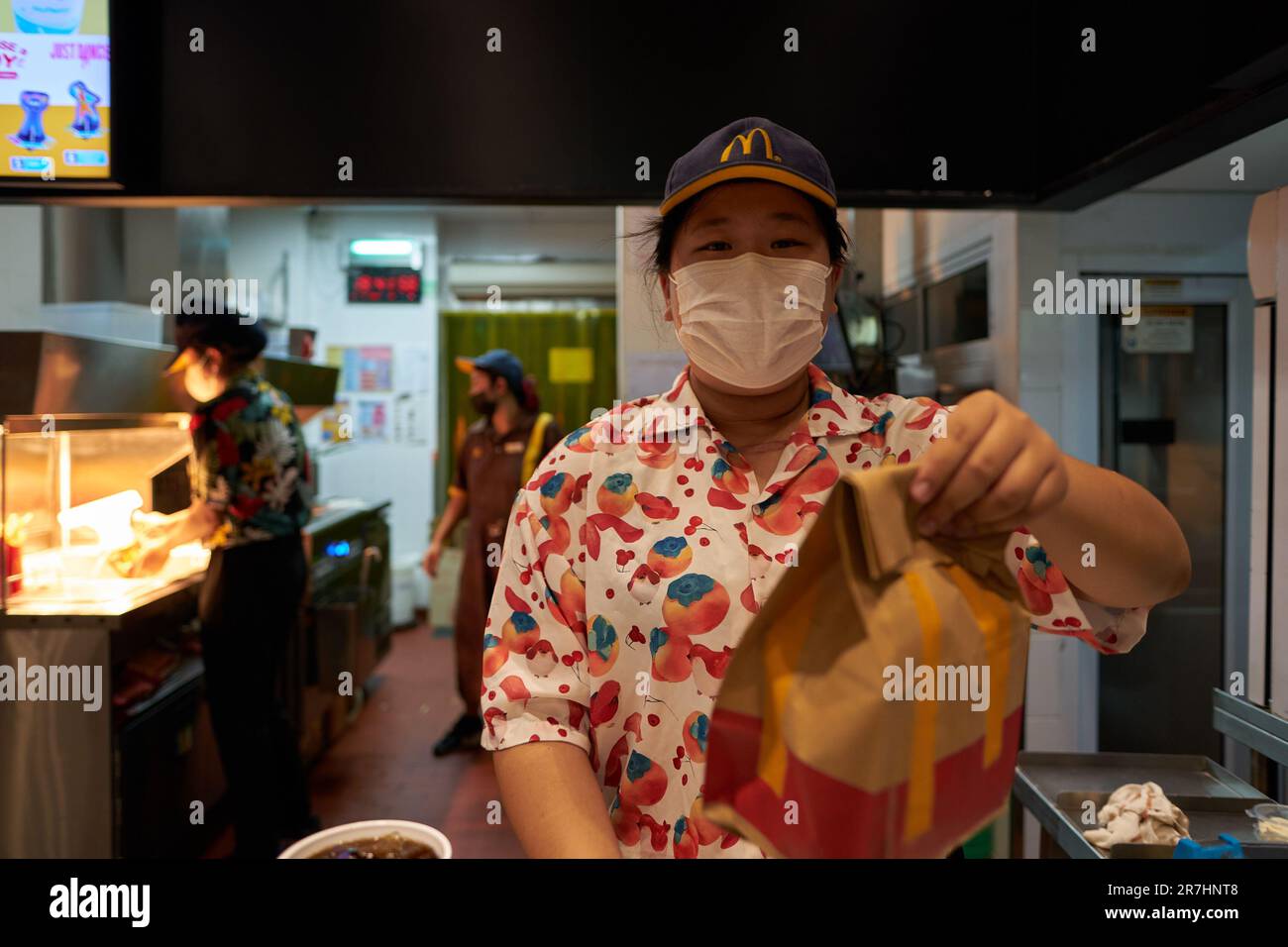 PATTAYA, THAILAND - CIRCA APRIL, 2023: portrait of McDonald's fast food restaurant employee with order in Pattaya. Stock Photo