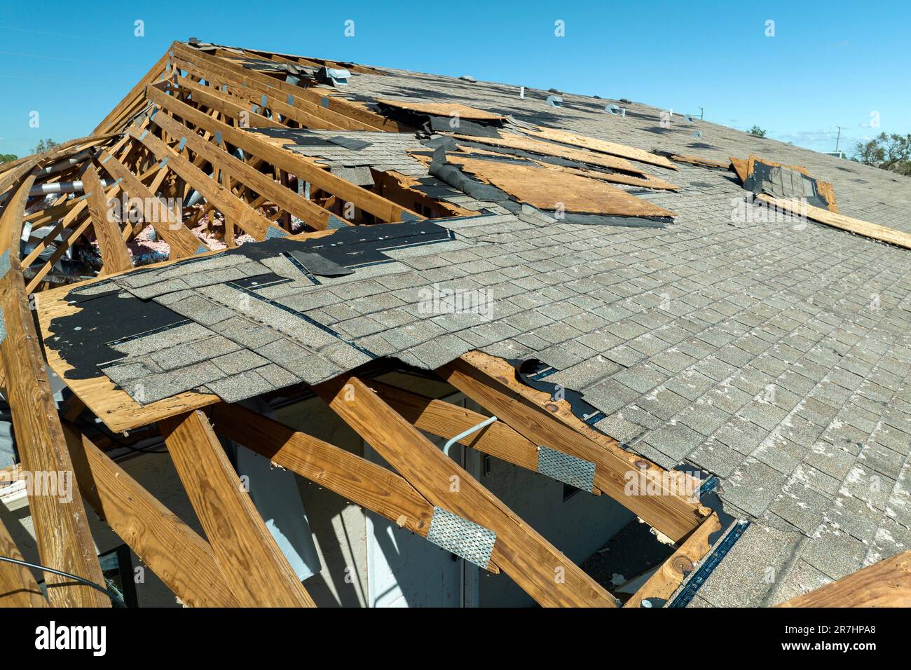 Natural disaster and its consequences. Hurricane Ian destroyed house roof in Florida residential area. Stock Photo